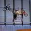 Two motorcyclists are jumping their bikes high into the air..jpg